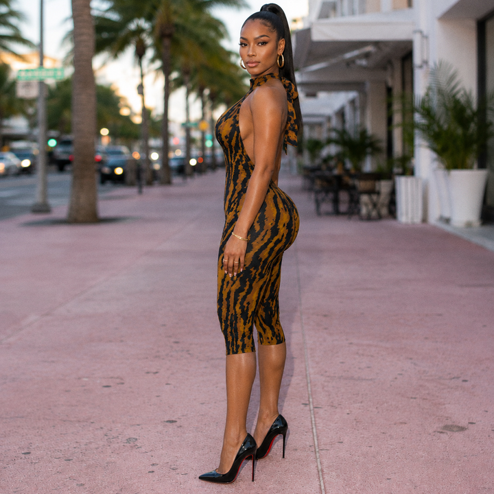 Side view of the Celine Capri in tiger stripe print showing the halter tie and knee-length capri leg