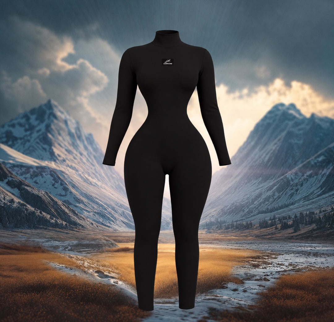 Front view of the Dark Desire Jumpsuit, a black long sleeve mock neck jumpsuit with a small white JLorraine chest label and slim full length legs