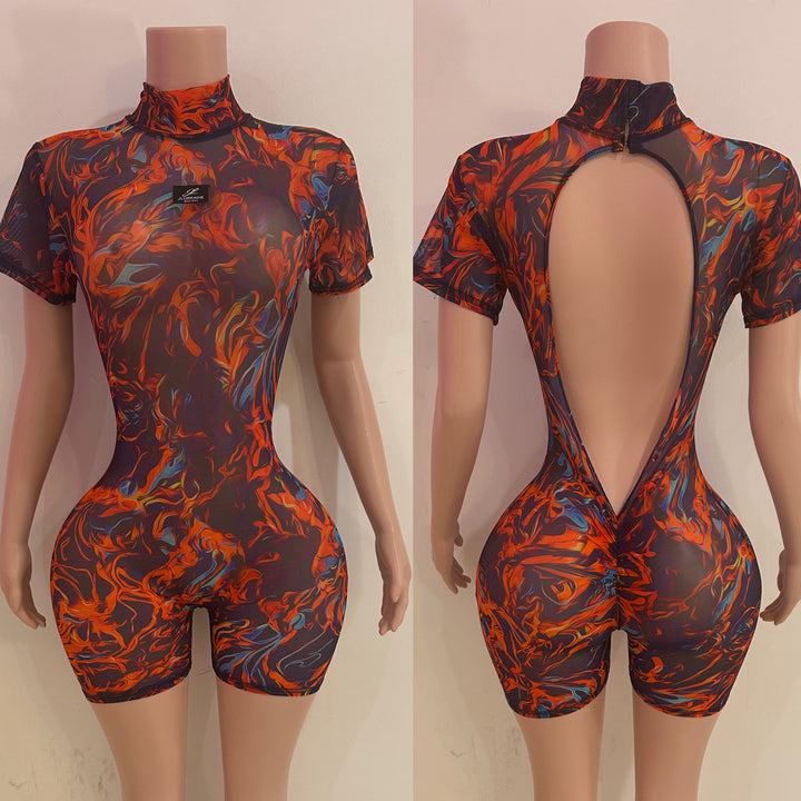 Short-sleeve, open-back romper with fiery pattern on a mannequin against a neutral background