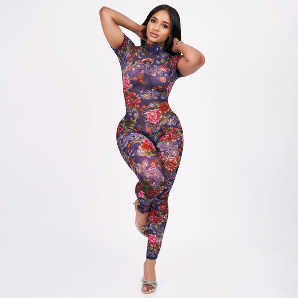 Woman wearing a floral jumpsuit on a white background
