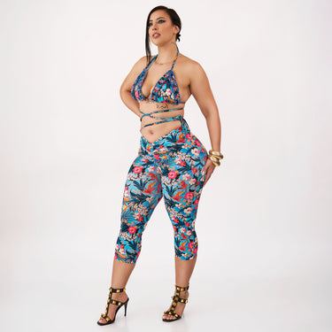 Woman wearing a colorful floral outfit on a white background