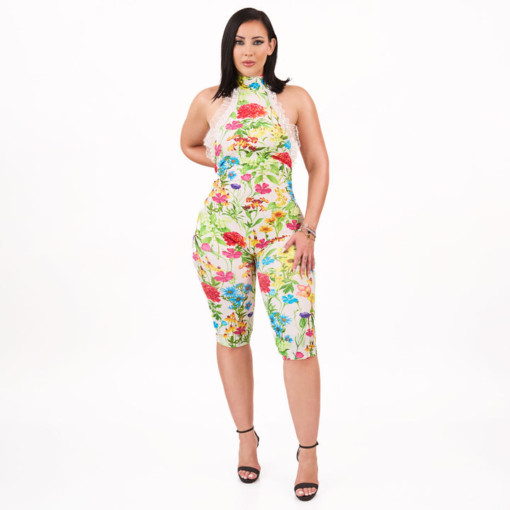 Woman wearing a colorful floral jumpsuit on a white background
