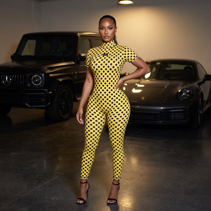 Model wearing the Sanity Jumpsuit in yellow polka dot - front view